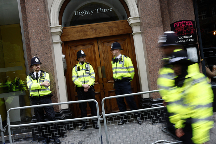 Police officers stand on duty outside the entrance to a building housing the headquarters of the Reform UK political party, during a 'Stop the Far-right' demonstration on a National Day of Protest in London on Aug. 10, 2024.